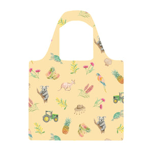 Loving Our Sunburnt Country Reusable Shopping Bag by Cass Deller, a soft yellow bag printed with tractors, gum leaves and country Australian motifs