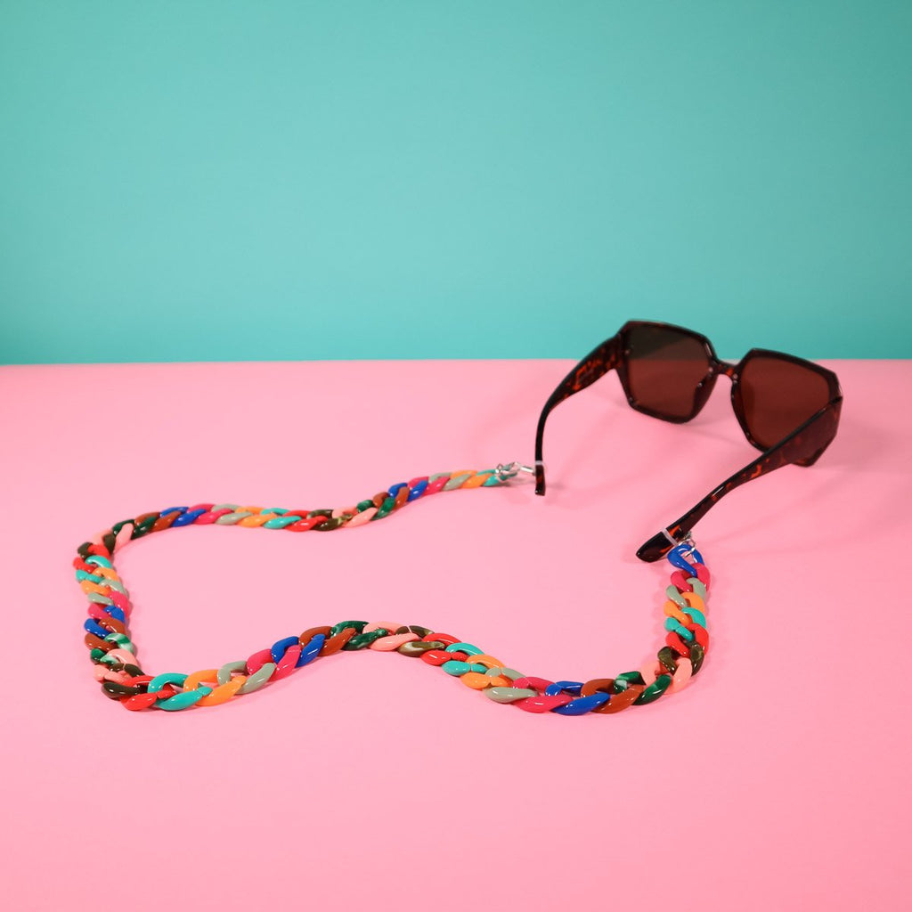 Multi coloured mask chain attached to tortoise shell glasses. 